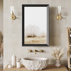 a bathroom sink sitting under a mirror next to a faucet and wall light