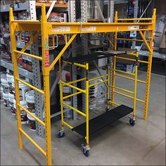 an assembly line in a factory with workers working on the metal structure and other equipment