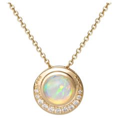 From the Blue Hour Collection - this is a single, elegant pendant in 14ky with a 7.5mm round and flashing blue Ethiopian Opal cabochon surrounded by 11 natural diamonds (0.1605ct). The chain is 18" 14ky cable chain with a lobster clasp. The amazing flashes of blues, greens and pinks and oranges of the opal will make you so happy! Important: Your lovely opal is a little fussy (just like good pearls). Avoid liquid chemicals like perfumes, soaps and moisturizers. Remove the necklace before taking a Elegant Pendant, Blue Hour, Take A Shower, Jewelry Vintage, Ethiopian Opal, Cable Chain, Antique Furniture, On Earth, Lobster Clasp