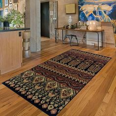 a living room filled with furniture and pictures on the wall