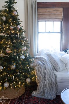 a living room with a christmas tree in the corner