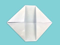 an origami paper airplane on a blue background