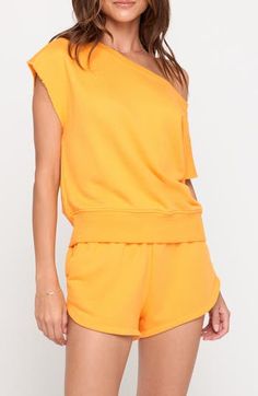 Raw edges and a boxy fit add to the laid-back appeal of this off-the-shoulder top fashioned in a vibrant solid hue. 22" length (size Medium) Off-the-shoulder neck Short sleeves 75% cotton, 25% modal Machine wash, tumble dry Made in the USA Casual Oversized Boat Neck Top, Casual Off-shoulder Top For Loungewear, Boxy Drop Shoulder Summer Tops, Boxy Drop Shoulder Tops For Summer, Oversized Off-shoulder Loungewear Top, Oversized Off-shoulder Cotton Top, Oversized Off-shoulder Summer Tops, Oversized Off-shoulder Tops For Summer, Yellow One Shoulder Top For Summer