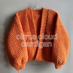 an orange sweater with the words circus cloud cardigan on it