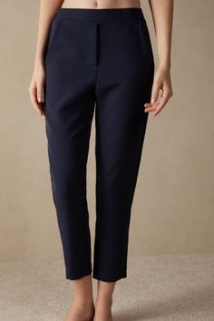 Full-length trousers featuring two pockets, faux back pocket and covered elasticated waist. Chic Blue Bottoms With Straight Hem, Elegant Blue Pants With Elastic Waistband, Elegant Stretch Bottoms With Side Pockets, Elegant Stretch Pants With Side Pockets, Elegant Office Bottoms With Side Pockets, Elegant Blue Pants With Straight Hem, Elegant Bottoms With Pockets For Work, Chic Pants With Pockets And Straight Hem, Elegant Workwear Bottoms With Pockets