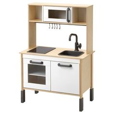 a wooden play kitchen with sink and microwave