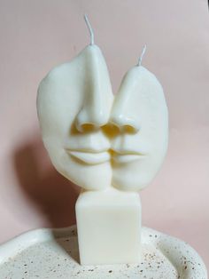 a close up of a candle with a face on it