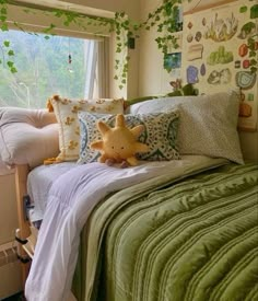 a bed with green comforter and pillows on top of it next to a window