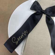 a white plate topped with a black ribbon