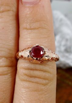 Natural Ruby Ring Description Floral Wedding Design#154 Custom This is a Victorian/Edwardian reproduction ring in 10k rose gold filigree with a natural red ruby gemstone solitaire. This full cut round cut red ruby gemstone is 4mm in diameter. The inside of the band is marked 10K for gold. Notice the beautiful floral design of the gold filigree setting. This is a lovely rendition of an Antique filigree ring, and it is ready to wear. A gift ring box is included and all rings are shipped in the rin Antique Rose Gold Ruby Jewelry, Ruby Filigree Wedding Ring, Gold Ruby Wedding Ring 14k, Victorian Rose Gold Ruby Ring For Anniversary, Wedding Ruby Ring With Intricate Design, Intricate Ruby Wedding Ring, Ornate 14k Gold Ruby Ring For Anniversary, Gold Filigree Ruby Wedding Ring, Heirloom Ruby Ring With Intricate Design For Promise