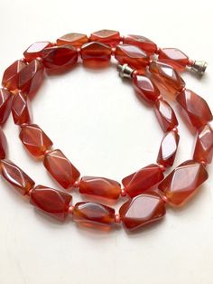 Natural red carnelian stone necklace deep even color 11 x 6 mm hexagon rectangular stones, 18inches long, barrel clasp, carnelian is represented as the stone of courage & endurance Luxury Single Strand Carnelian Beaded Necklace, Red Rectangular Spiritual Jewelry, Spiritual Red Rectangular Jewelry, Red Faceted Carnelian Necklaces, Red Faceted Carnelian Jewelry, Red Carnelian Single Strand Necklace, Red Carnelian Beaded Necklace With Faceted Beads, Red Carnelian Faceted Beaded Necklaces, Red Carnelian Necklace With Faceted Beads