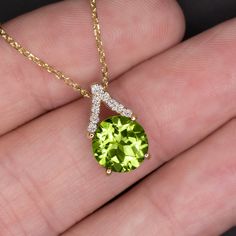 This elegant peridot and diamond pendant features a bright green peridot set beneath a glittering V of vibrant pave set diamonds. The vivid chartreuse of the peridot pops beautifully against the bright white of the diamonds. The pointed bail creates a subtle geometric look that gives this pendant a modern edge while still maintaining a sophisticated and timeless aesthetic. This pendant will add a bright pop of color to your wardrobe!The 8mm peridot center is a gorgeous and well saturated yellow- Peridot Necklace Vintage, Leo Signs, Filigree Wedding Band, Vintage Engagement Ring Settings, Peridot Color, Bright Pop, 14k Yellow Gold Necklace, Peridot Jewelry, Peridot Earrings