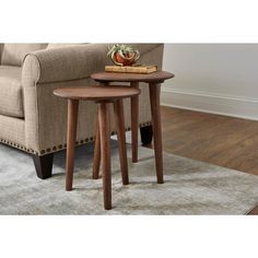 two wooden tables sitting on top of a rug