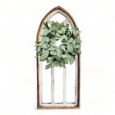 an old window frame with a wreath on the front and side, against a white background