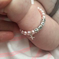 a baby's hand with a bracelet that says i love you