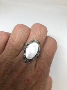 Lovely polished sterling silver has the look of Deco with a huge white Mother Of Pearl set in very detailed vintage filigree Size 7.75 We can size these with an additional $10-$20 fee for the jeweler All rings are shipped in a nice gift box. Check out our over a THOUSAND great reviews Engraving is $4 per letter and is not always perfect depending on the piece. It can take a few days if the jeweler is busy. This is payable to Paypal Judithsltd@gmail.com White Filigree Fine Jewelry, White Fine Jewelry With Filigree Details, White Fine Jewelry With Filigree, Fine White Filigree Jewelry, White Filigree Jewelry For Formal Occasions, White Sterling Silver Rings Engraved, White Engraved Sterling Silver Rings, Engraved White Sterling Silver Rings, Classic White Filigree Ring With Intricate Design