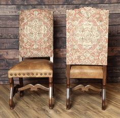 two brown chairs sitting next to each other on top of a wooden floor