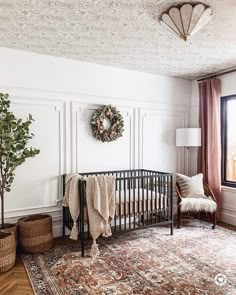 a baby crib in the corner of a room with a rug on the floor