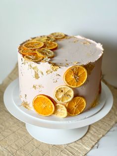 a white cake with orange slices on it