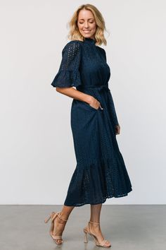 Simple and classic for every occasion Woven eyelet material Deep Navy Blue color Fit runs big, we recommend sizing down Banded collar with ruffle Functioning buttons down front of dress Mid-length sleeve with ruffle Natural waist with self-tie sash Midi length skirt with single tier Hidden side pockets Dress lined to top of tier, unlined sleeve Self: 100% Cotton, Lining: 97% Polyester, 3% Spandex Trina is 5'6, cup size 32D, size 2 and is wearing size XS Fitted Eyelet Midi Dress For Daywear, Eyelet Short Sleeve Dresses For Brunch, Short Sleeve Eyelet Dress For Brunch, Fitted Eyelet Dress, Midi Length, Fitted Eyelet Midi Dress, Fitted Eyelet Dress Midi Length, Elegant Short Sleeve Eyelet Dresses, Chic Eyelet Midi Dress, Chic Fitted Eyelet Midi Dress