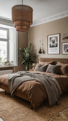 a bedroom with a large bed and two pictures on the wall