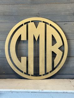 a circular monogrammed sign on the side of a building