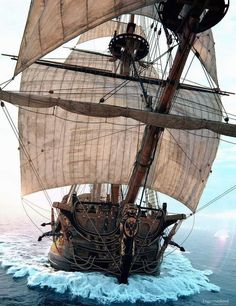 an old sailing ship in the middle of the ocean