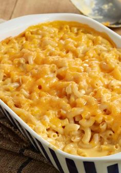 a casserole dish filled with macaroni and cheese next to a fork