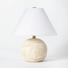 a table lamp with a white shade on it