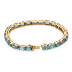 This is part of Chairish’s Fine Jewelry assortment.  This 18.5 ct Blue Topaz Tennis Bracelet in 18K gold showcases 25 endlessly sparkling natural blue topaz, weighing 18.5 carats. It measures 7.25 inches long in length.  Blue topaz helps to improve communication and self expression.  Designed with perfect octagon cut blue topaz set in solid gold basket settings in repetition making a beautiful bracelet to make you stand out on any occasion or event. The elegant style complements the attire beautifully and this is a perfect Unique Gift, Bridal Shower Gift, Secret Santa Gift, Gift For Sister, Mother Daughter Gift, Bride To Be Gift, Bridesmaid Gift, Thanksgiving Gift, Anniversary Present, Christmas Gift or any Holiday Gift for Mother, Sister, Daughter, Grandma, Fiancé, Girlfriend, Valentine, Luxury Aquamarine Yellow Gold Jewelry, Luxury Blue Topaz Gemstone Bracelets, Luxury Aquamarine Jewelry In Baguette Cut, Luxury Blue Topaz Bracelets, Luxury Blue Topaz Bracelets For Formal Occasions, Luxury Aquamarine Baguette Cut Jewelry, Elegant Gold Aquamarine Bracelet, Yellow Gold Bracelet With Blue Topaz For Gifts, Yellow Gold Bracelets With Blue Topaz For Gift