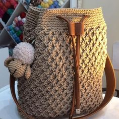 a crocheted bag with a poodle on the handle