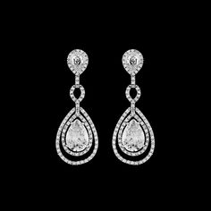 Hollywood glam bold dazzling and sophisticated CZ wedding bridal Earrings.the perfect drop earring for the bride that loves tradition but just needs to all a little more bling.Absolutely gorgeous 2 1/4" long drop High End Cubic Zirconia wedding earrings. ---------------------------------------------------------------add our beautiful crystal bracelet (sold separately) measures approx 6 3/4- 7" long small to standard fit + extender if needed *Note processing time is not shipping time, our regular Diamond White Pear-shaped Bridal Earrings For Evening, Diamond White Teardrop Chandelier Earrings For Evening, Evening Bridal Drop Earrings With Diamond Accents, Pear-shaped Bridal Earrings For Evening, Diamond White Teardrop Bridal Earrings For Evening, Glamorous Wedding Diamond Earrings With Elegant Design, Glamorous Diamond Earrings With Elegant Design For Wedding, Dazzling Diamond White Pear-shaped Bridal Earrings, Teardrop Diamond White Chandelier Earrings With Elegant Design