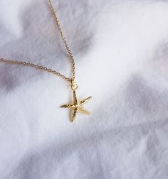 Necklace with a small starfish made of high-quality 925 sterling silver with 14 carat multiple gold plating. The piece of jewelry is covered with 2 layers of gold - a base layer and a top layer, which increases the durability of the coating. The chain is available in three lengths and comes with an extension of approx. 5 cm. The pendant has a size of 20 mm. 🤍 Nickel free 🤍 Rustproof 🤍 Hypoallergenic 🤍 no discoloration This necklace is also available in silver! https://www.etsy.com/de/listing Gold Starfish Clavicle Chain Necklace, Gold Starfish Charm Necklace, Yellow Gold Starfish Charm Jewelry For Beach, Elegant Starfish Charm Jewelry As Gift, Elegant Starfish Charm Jewelry For Gifts, Yellow Gold Starfish Necklace As Gift, Elegant Starfish Charm Jewelry Gift, Dainty Gold Starfish Charm Necklace, Gold Charm Necklace With Starfish Charm