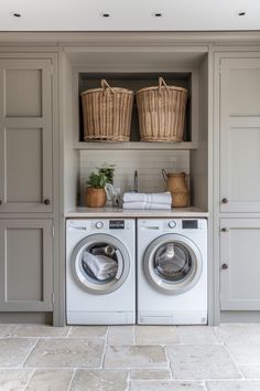 Laundry room with a washing machine and dryer side by side, baskets above, and plants on the counter. Utility In Kitchen Ideas, Small Utility Cupboard Ideas, Storage And Laundry Room Ideas, Small Laundry Room Ideas With Storage, One Wall Utility Room, Utility Small Room Ideas, Utility Room Storage Ideas Small Laundry, Boot Room Ideas Utility, Contemporary Utility Room