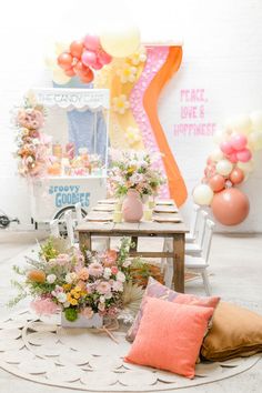 a table with flowers and balloons in the background