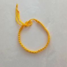 Handmade Yellow String Bracelet Adjustable Yellow Bracelets For Friendship, Adjustable Yellow Bracelet For Friendship, Yellow Braided Bracelet For Gift, Yellow Braided Friendship Bracelets, Yellow Beaded Bracelets With Sliding Knot As Gift, Yellow Beaded Bracelets With Sliding Knot For Gifts, Yellow Beaded Bracelet With Sliding Knot As Gift, Handmade Adjustable Yellow Bracelet, Adjustable Yellow Bracelets As Gift