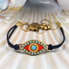 Michal Golan Turquoise, Gold and Coral Evil Eye Pendant Bracelet on Etsy. Gorgeous! Turquoise Round Evil Eye Jewelry, Adjustable Turquoise Evil Eye Bracelet, Spiritual Multicolor Evil Eye Jewelry, Multicolor Evil Eye Spiritual Jewelry, Turkish Glass Evil Eye Bracelet Gold Metal, Victorian Style Jewelry, Handmade Evil Eye, Evil Eye Pendant, Evil Eye Necklace