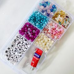 a plastic container filled with lots of different colored beads