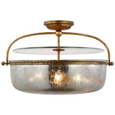 an old fashioned light fixture with a glass bowl on the top and metal frame around it