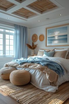 a large bed sitting in a bedroom next to a window covered in blue and white blankets