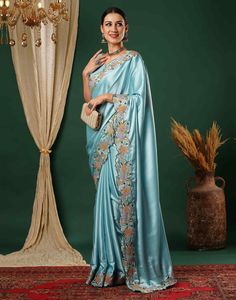 Sky Blue Embroidery Satin Saree  Sky Blue Embroidery Satin Saree is a glamorous and luxurious piece. The rich satin fabric drapes beautifully, creating a flowing and elegant silhouette.  Features Of Sky Blue Embroidery Satin Saree  Traditional Handloom Craft  Intricate Gold Brocade Work  Durability and Longevity   Size Fit  The model height is 5.7 ft   WASH AND CARE  Hand Wash only. Do not dry in direct sunlight    Legal Disclaimer:  The product is guaranteed to be 100% genuine. Product images are for illustrative purposes only. Images/packaging/ labels may vary from time to time due to changes made by the manufacturer's manufacturing batch and location. The product description is for information purposes only and may contain additional ingredients. Diwali Traditional Wear With Resham Embroidery On Satin, Diwali Satin Traditional Wear With Resham Embroidery, Traditional Satin Saree For Reception, Traditional Satin Wear With Resham Embroidery, Festival Embroidered Satin Traditional Wear, Embroidered Bollywood Traditional Wear In Satin, Embroidered Satin Traditional Wear For Diwali, Diwali Embroidered Satin Traditional Wear, Satin Saree With Resham Embroidery For Eid