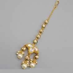 a gold necklace with pearls and stones