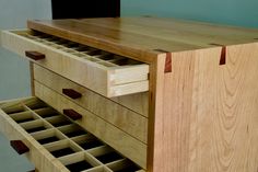 a wooden cabinet with several drawers on it