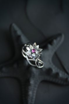 ITEM DESCRIPTION: The size of ring 6 3/4 (US and Canada) N 1/2 (UK and AU) I can make it any size you want - just mark your size in the order And you can order this lotus ring with another gemstone - please write to me before order. Weight - 2 g. Lotus flower ring was made by me of sterling silver and natural rhodolite garnet. It looks so transparent and light, like a piece of elver jewelry. The floral ring will be a great addition to your jewelry collection or a special piece for Engagement. Oo Silver Flower Jewelry For Proposal, Silver Wire Wrapped Flower Jewelry, Silver Flower Ring For Proposal, Bohemian Flower Ring For Promise, Whimsical Sterling Silver Wedding Jewelry, Bohemian Flower Wedding Ring, Unique Adjustable Flower Ring For Wedding, Unique Adjustable Flower Promise Ring, Handmade Elegant Flower Toe Ring