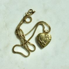 "This necklace is handmade by me and features all vintage components. The necklace chain is a vintage solid brass box chain that is 16\" in length with a functioning heart locket that is 0.79\" x 0.9\" in size. Please note the metal components are raw brass and as such, it is best to avoid humid environments or water exposure which can cause the brass to tarnish. There are brass cleaners available that assist with restoring the natural finish."