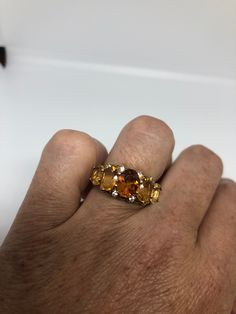 Unusual cut of citrine surrounded by white sapphires Sterling Filigree gold finished Setting Handmade Size 6 Can be resized, my jeweler charges a $10 fee All rings are shipped in a nice gift box. Check out our over a THOUSAND great reviews Engraving is $4 per letter and is not always perfect depending on the piece. It can take a few days if the jeweler is busy. This is payable to Paypal Judithsltd@gmail.com Fine Jewelry Citrine Topaz Ring With Accent Stones, Fine Jewelry Citrine Multi-stone Topaz Ring, Gold Topaz Multi-stone Ring, Gold Topaz Crystal Ring With Accent Stones, Anniversary Yellow Sapphire Topaz Ring With Accent Stones, Anniversary Citrine Gemstones With Accent Stones, Gold Topaz Ring With Gemstone Accents, Anniversary Rings With Yellow Sapphire And Gemstone Accents, Yellow Topaz Ring With Gemstone Accents For Anniversary