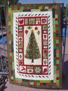 a quilted christmas tree on display in front of a swimming pool at the resort