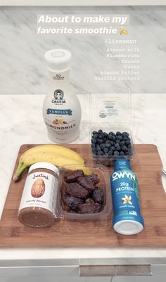 a wooden cutting board topped with fruit and yogurt