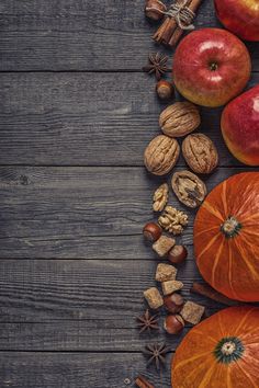 an assortment of nuts and apples on a wooden table