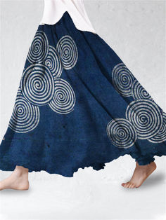 a woman's legs are shown in front of a blue skirt with circles on it